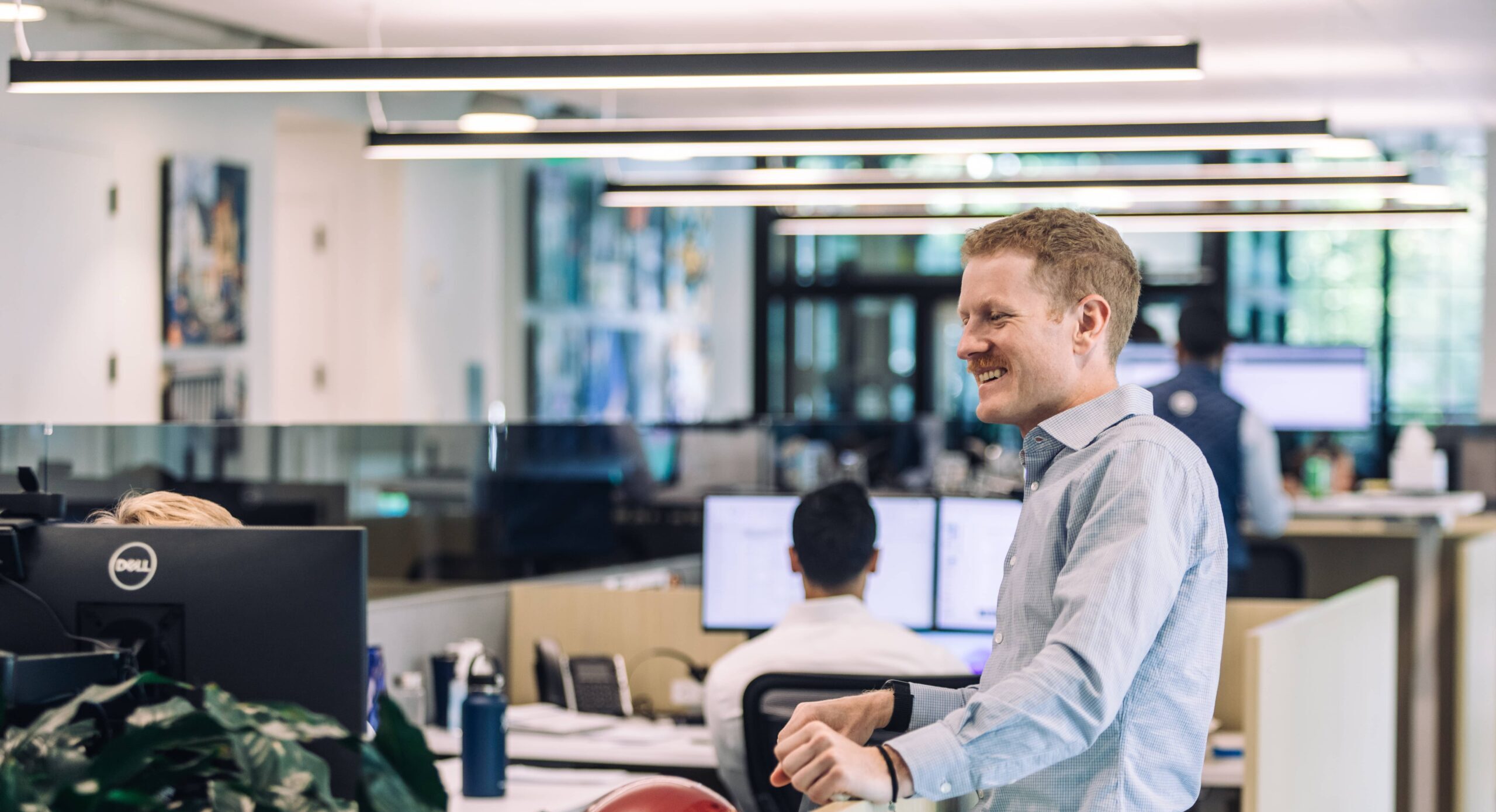 Employees Having a Conversation at Computer