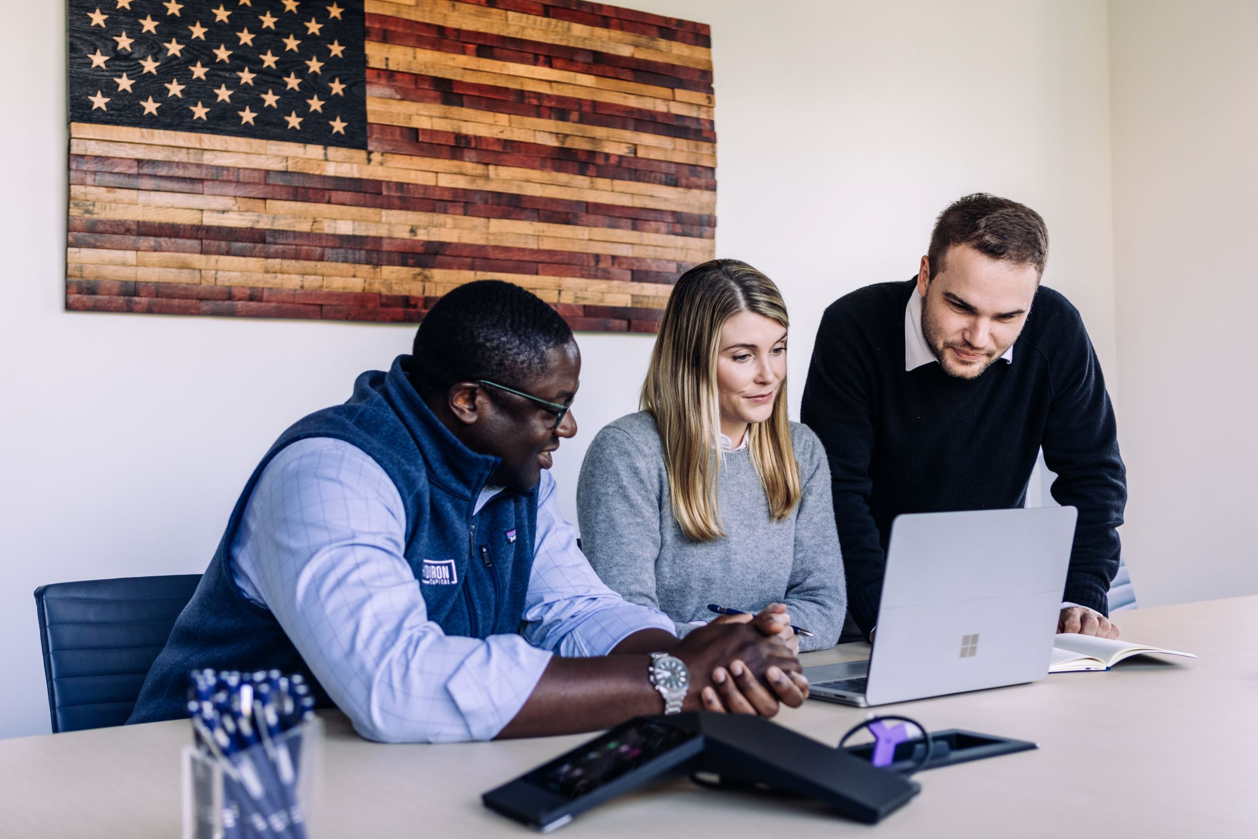 Gridiron Capital Team Around a Computer